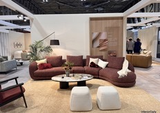 Soft and elegant couch from the new Nest Cool collection, featuring curved shapes and a striking red wine color for a visually appealing piece.