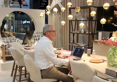 Hans Rodink, project manager at Steinhauer, worked behind his laptop as the new Belluno collection was showcased, featuring adjustable bullet lights with dimmable LEDs for enhanced table lighting and a warm ambiance.
