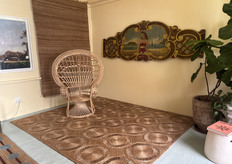 A still from the Herringbone showroom featuring a Rattan chair on top of one of their many luxury carpets available.