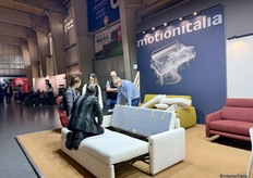 Januse Cieciwa from Motionitalia demonstrates the functionality of the sofa beds to visitors.
