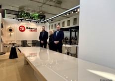 The team from Hubertus Design, in front of a giant long dining table they presented.