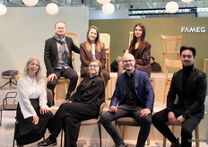 The FAMEG team posed with their latest chair collection, prominently displayed as the centerpiece of the stand.