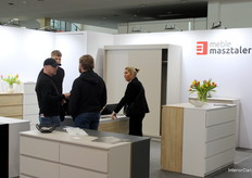 Representing Meble Masztalerz, CEO Jakub Masztalerz, young entrepreneur in the back, engaged with attendees at the brand’s Meble Polska booth.