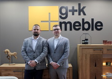 Dawid and Kamil posed in front of the flagship display of G+K Meble.
