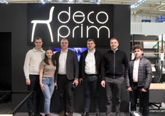 Representing Decoprim, the team posed together at the stand, showcasing their presence at the fair.