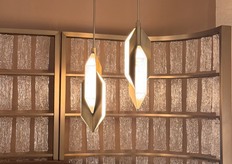 Modern lamp designs displayed alongside Maison Debrah’s newest bedding collection.