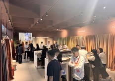 A busy scene at MAYAFAB’s stand, with visitors engaged in conversation with employees.