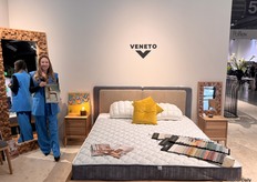 Anna Tsvyetkova, Sales Manager at Veneto, stood beside her hand-drawn painting and showcasing the colourful Veneto collection.