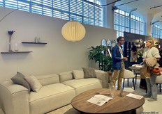 Bas Quist from agency Home For Brands in conversation with a visitor, at one of their brands from the portfolio, Bolia.