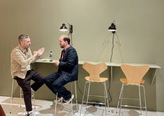 Pleasant conversation at the Fritz Hansen booth.