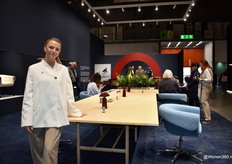 Hanne Demarcke from furniture factory Bulo, posing by a very large sustainable table that demonstrated the technique of veneering.
